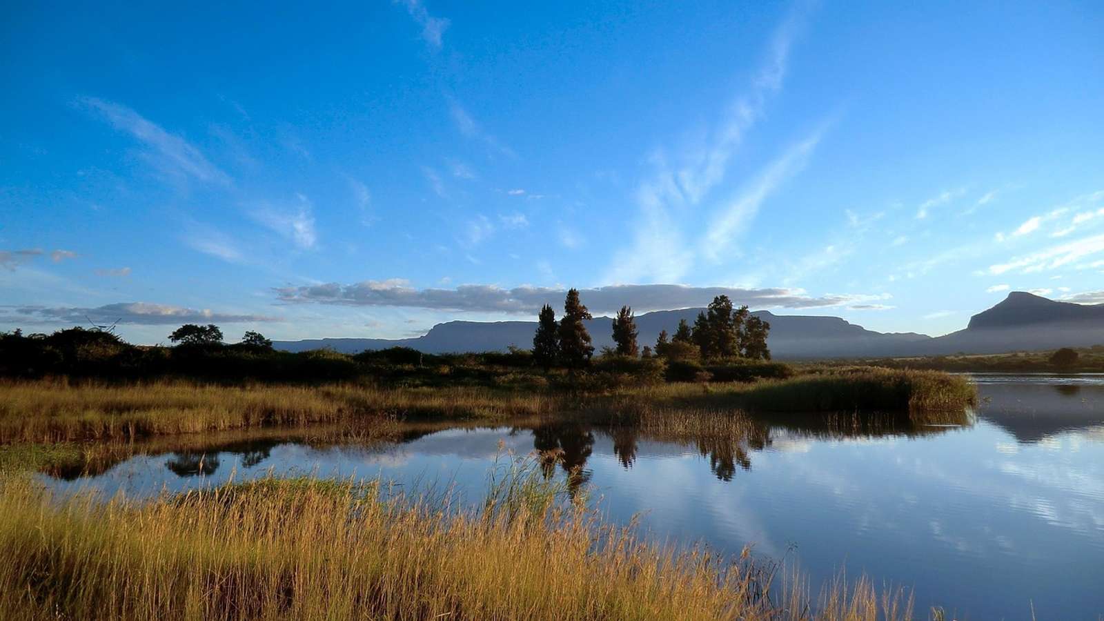 Rocky mountains and green slopes in the Drakensberg range in South Africa