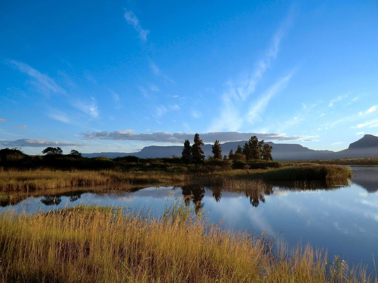 Rocky mountains and green slopes in the Drakensberg range in South Africa