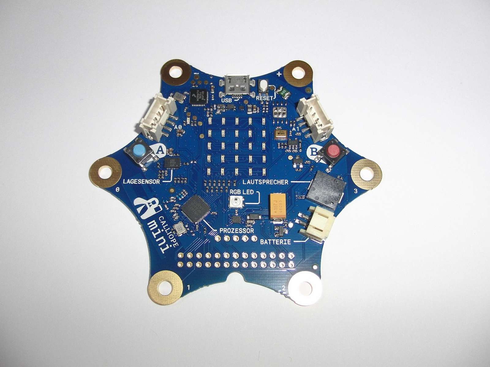 A blue hexagonal circuit board with small electronic components on a white background
