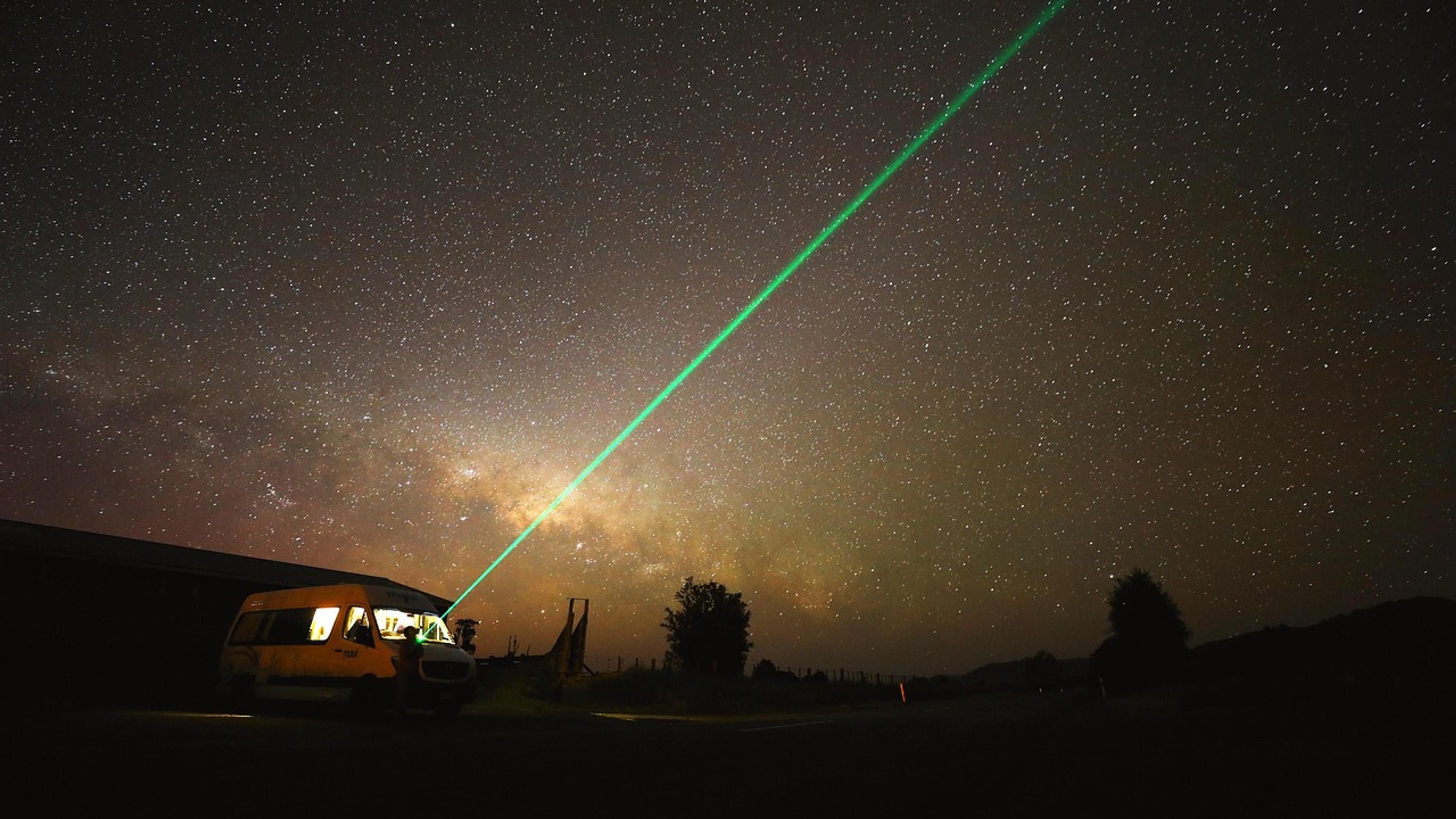 The Milky Way across a starry night sky above a dark landscape