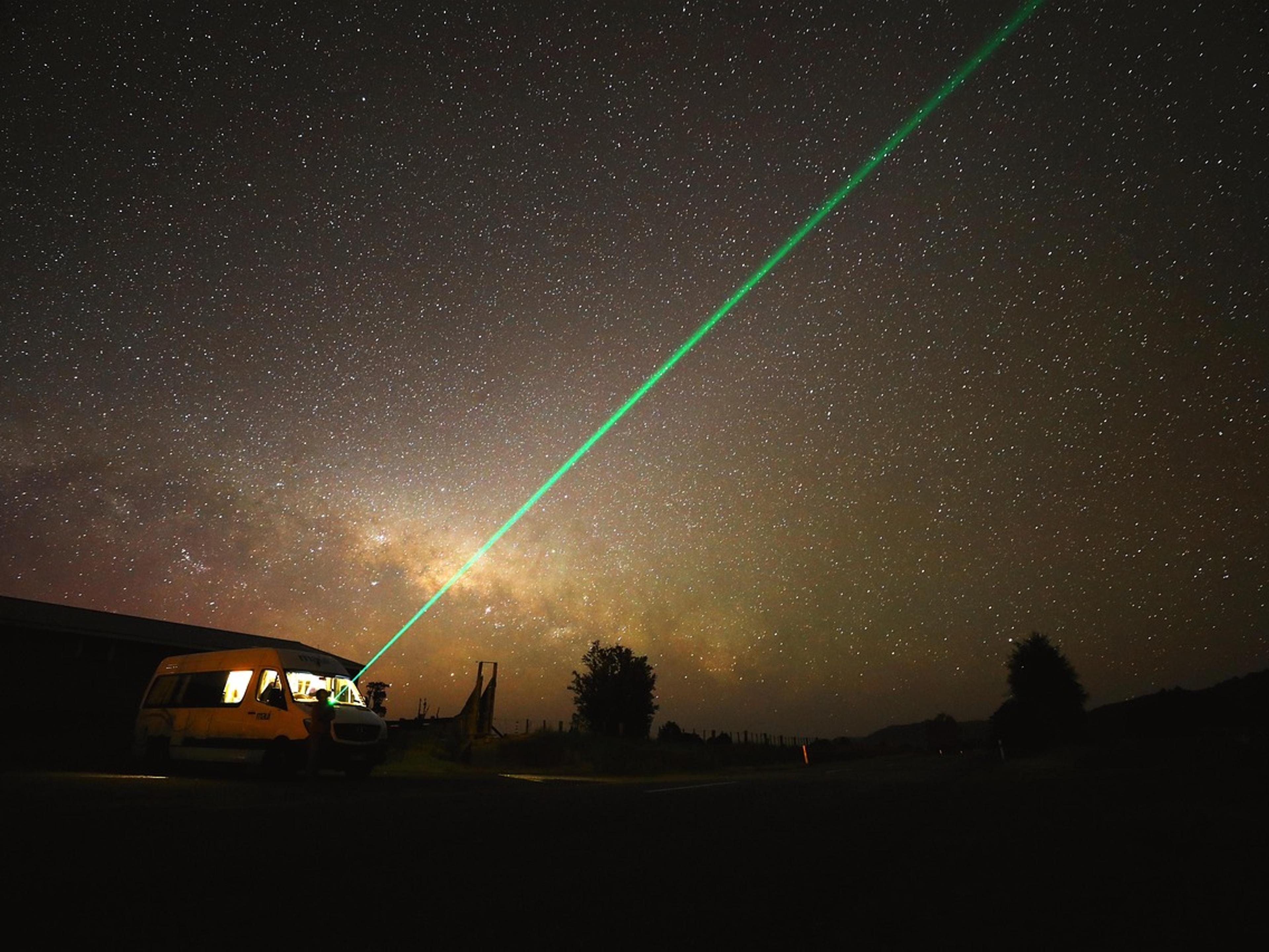 The Milky Way across a starry night sky above a dark landscape