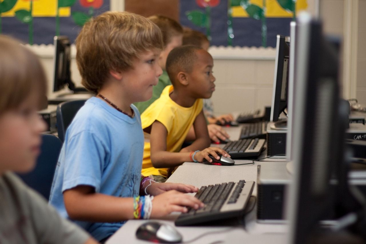 A young student working at a computer