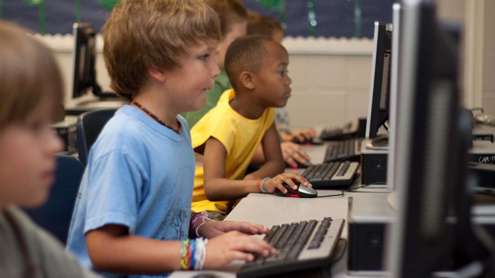 A young student working at a computer