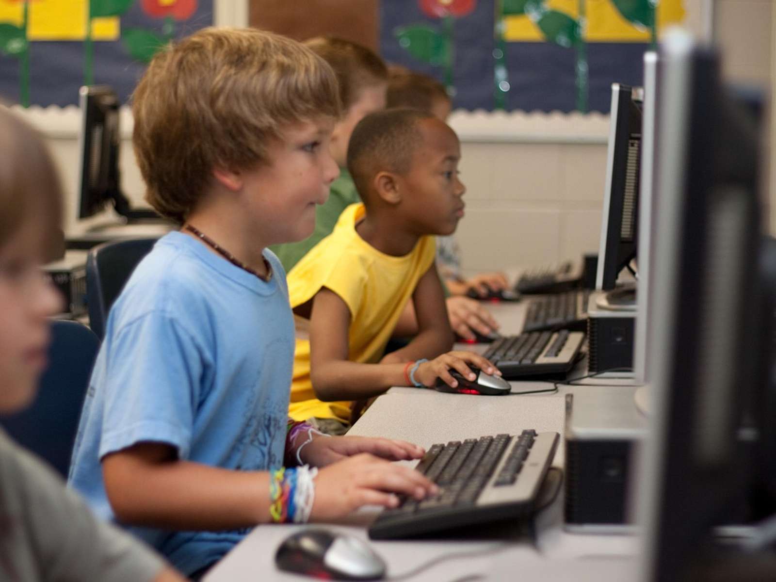A young student working at a computer