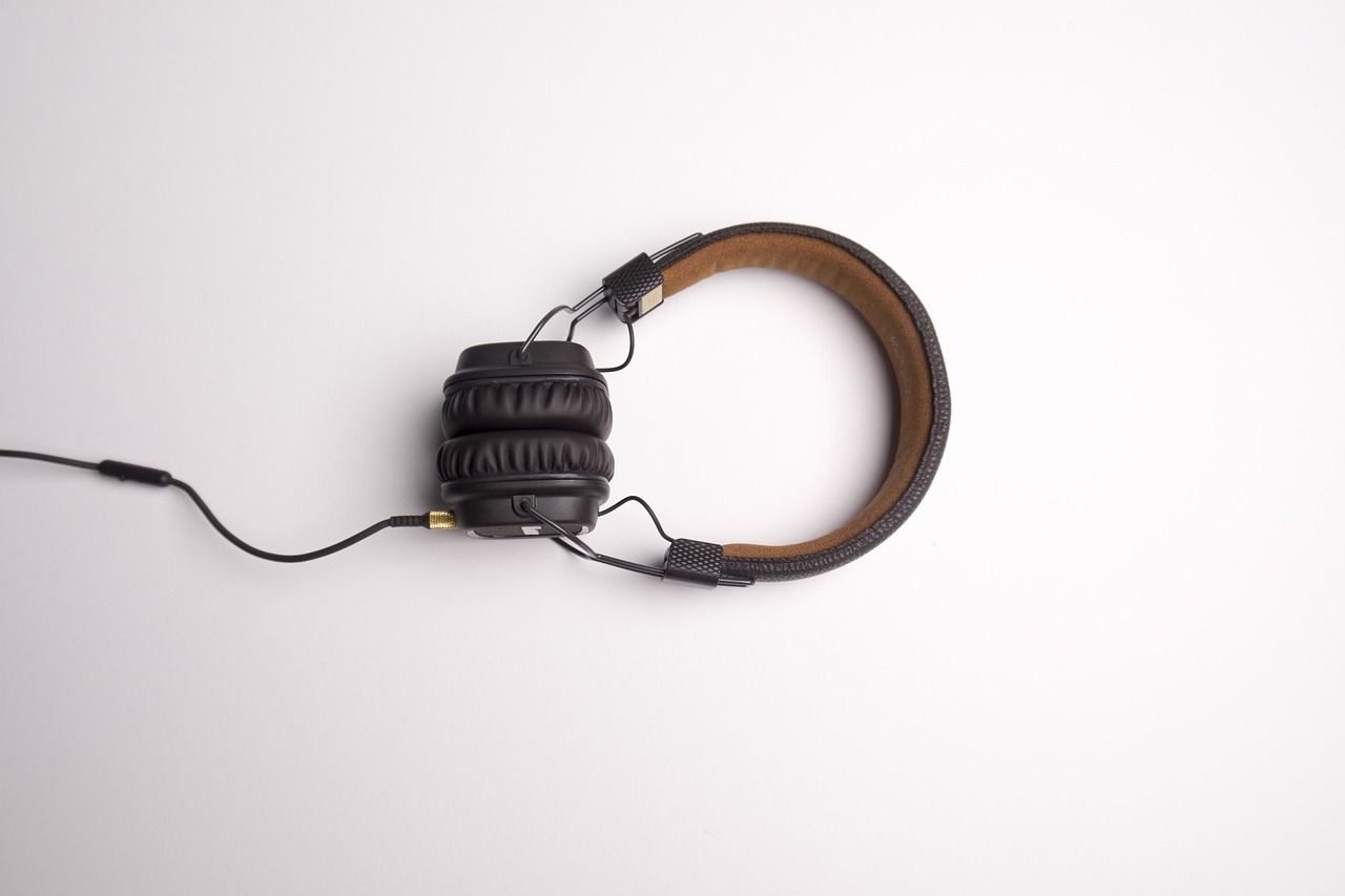 A pair of headphones with a cable on a white surface