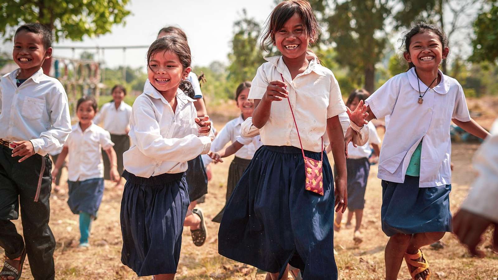 Children standing outdoors in the Cambodian countryside