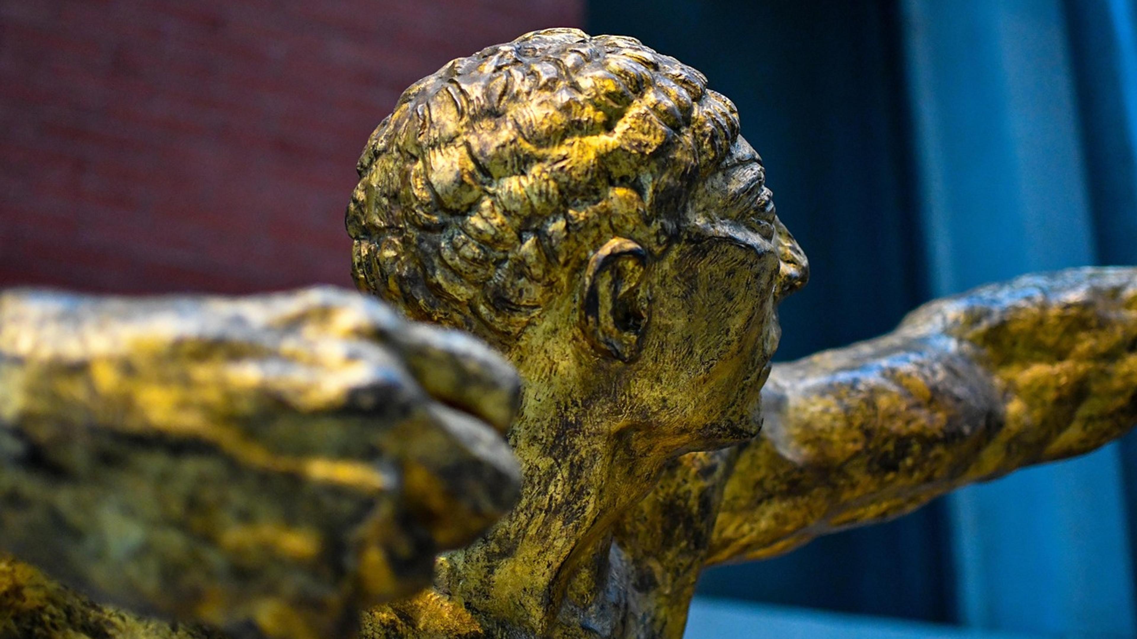 Ancient Greek bronze statue displayed in a museum