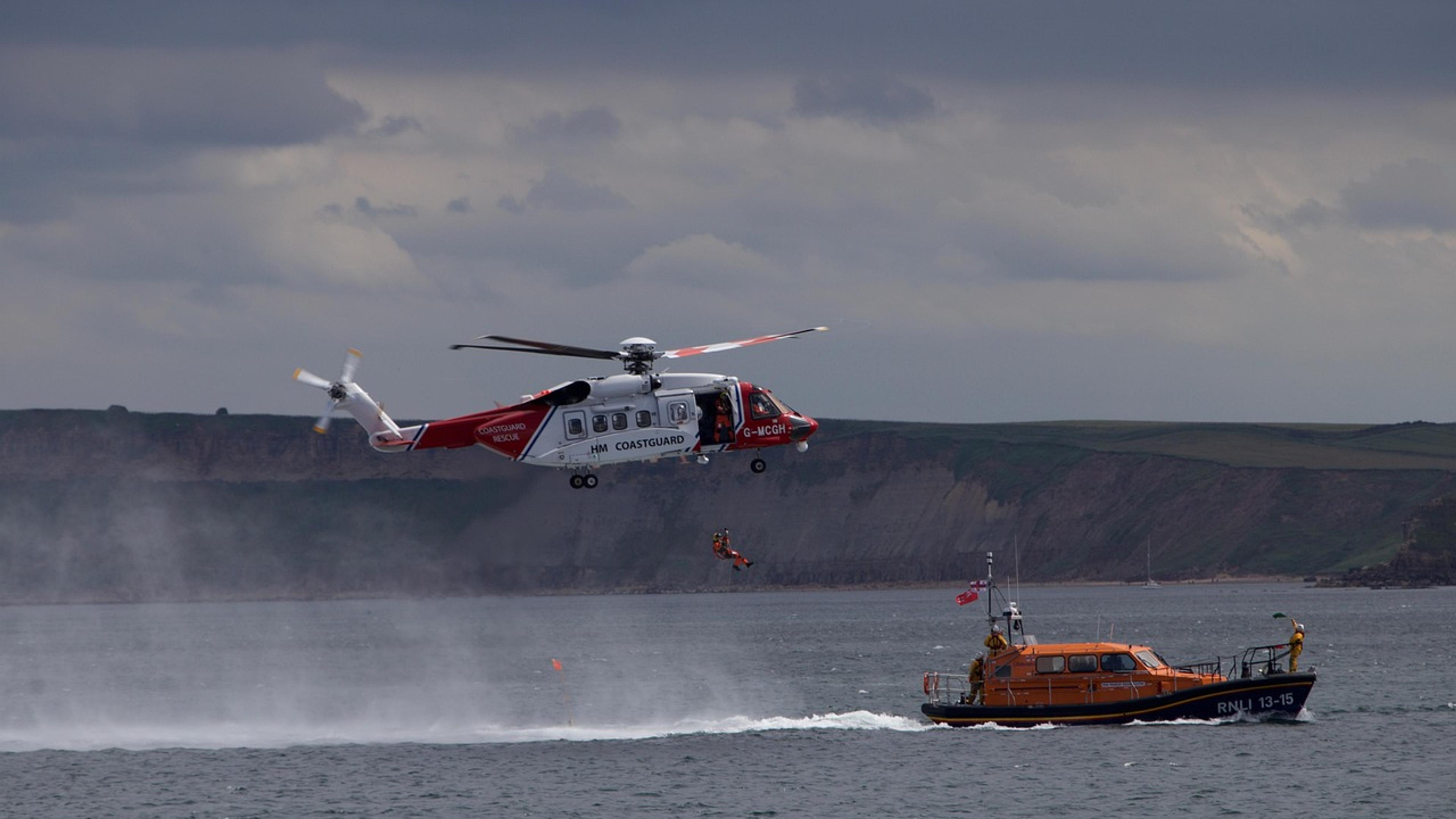 Rescue lifeboat and helicopter operating at sea