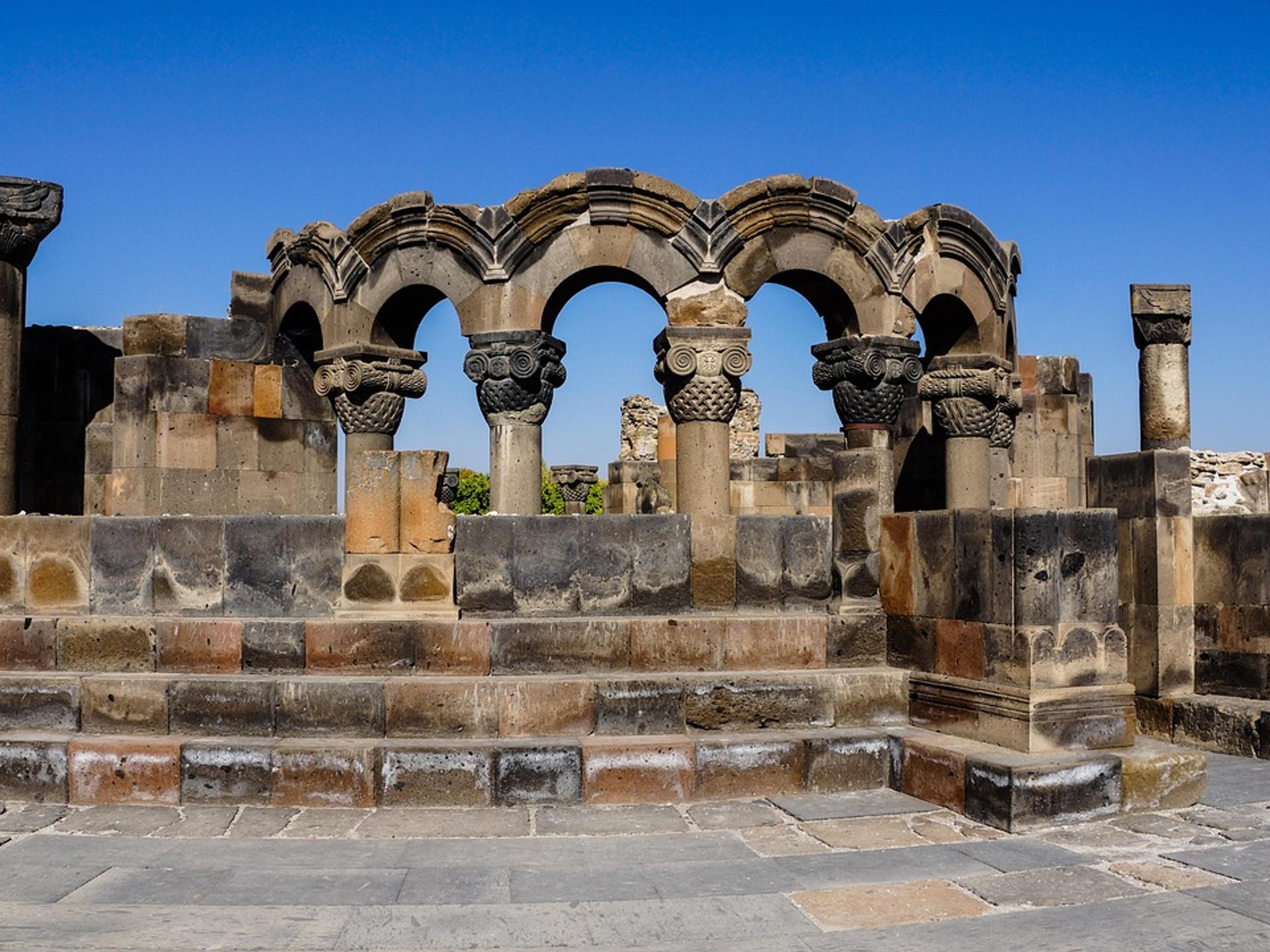 Ruined stone columns and arches of an ancient church
