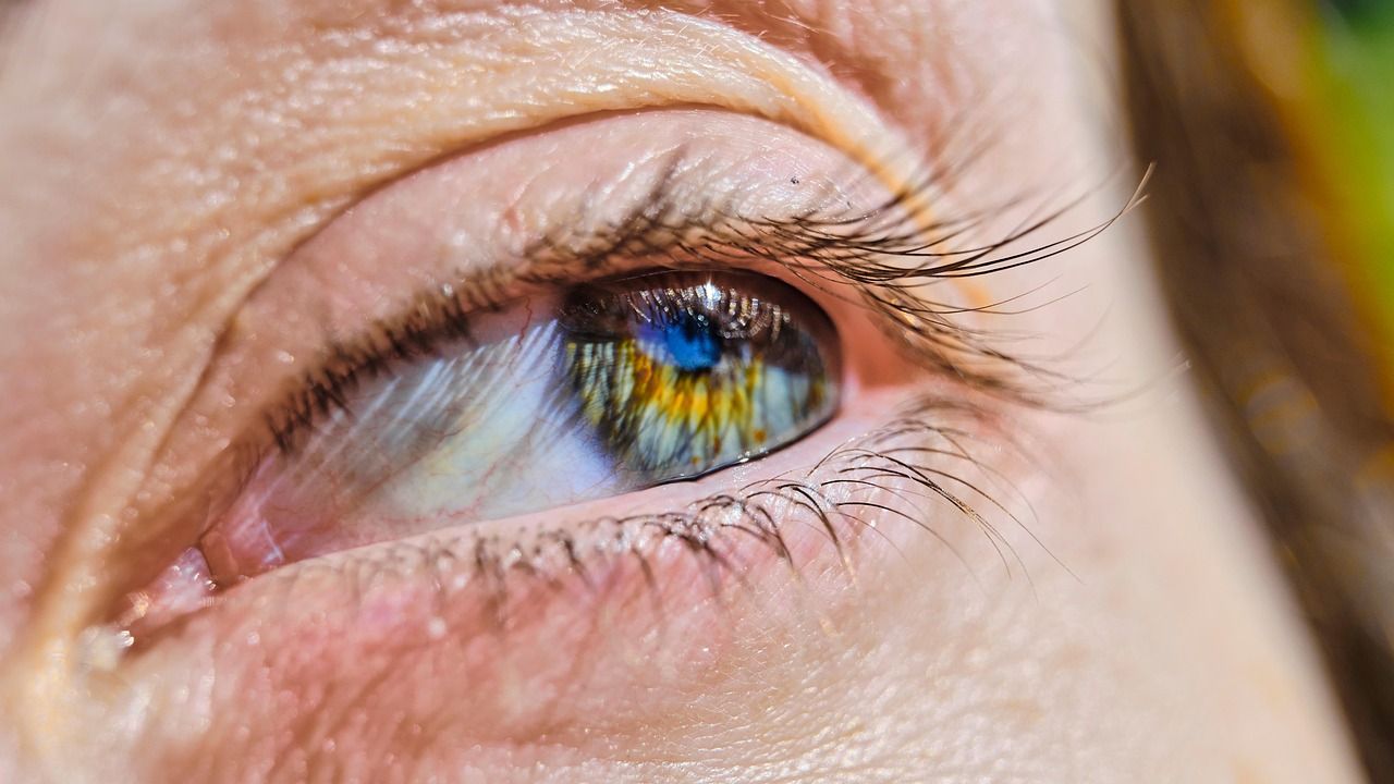 Extreme close-up of a human blue eye with eyelashes