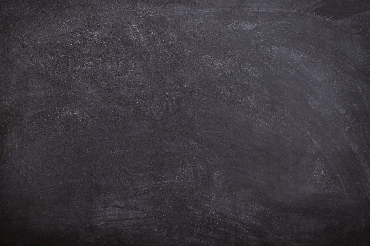 A black school chalkboard with traces of chalk