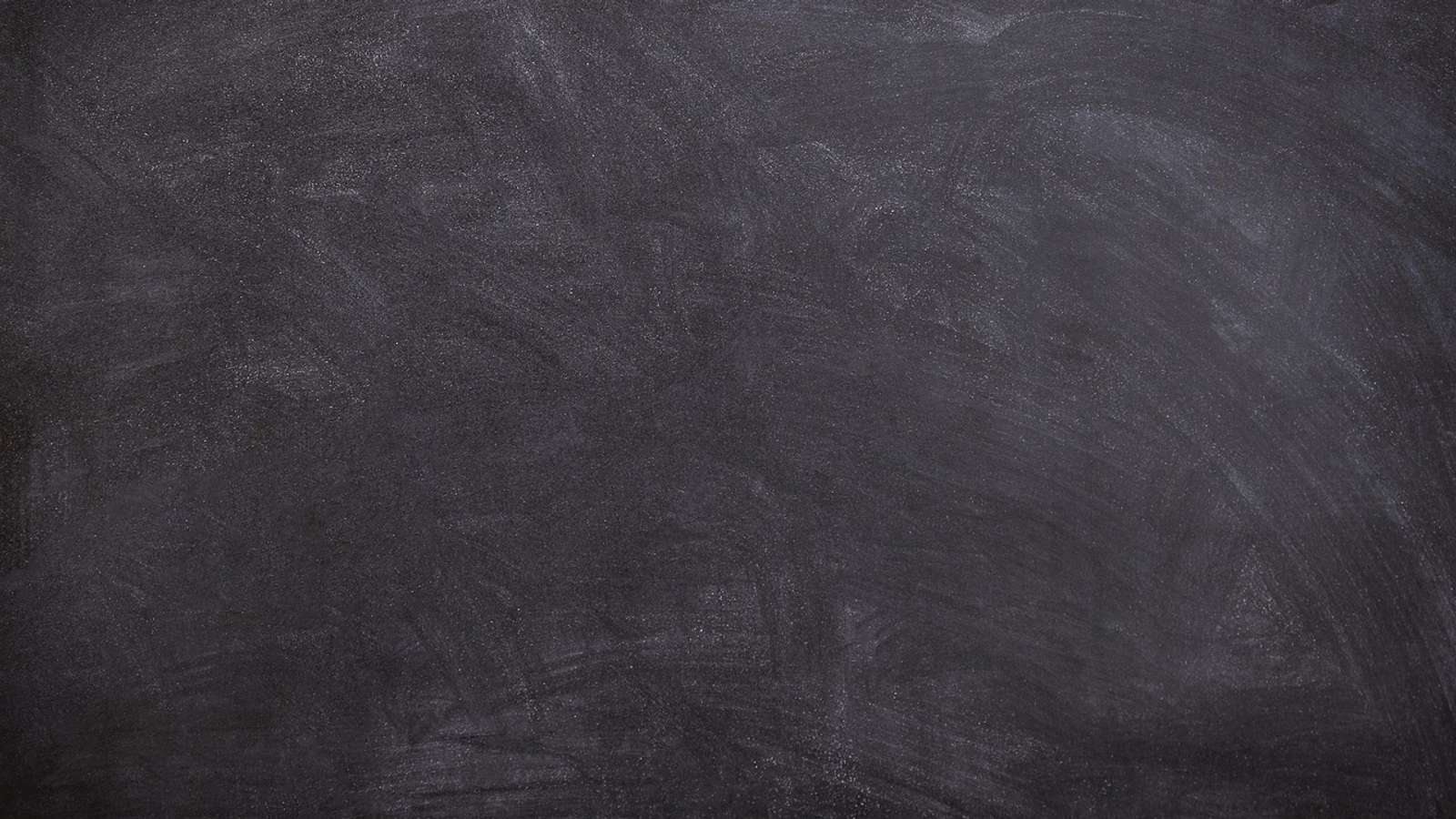 A black school chalkboard with traces of chalk