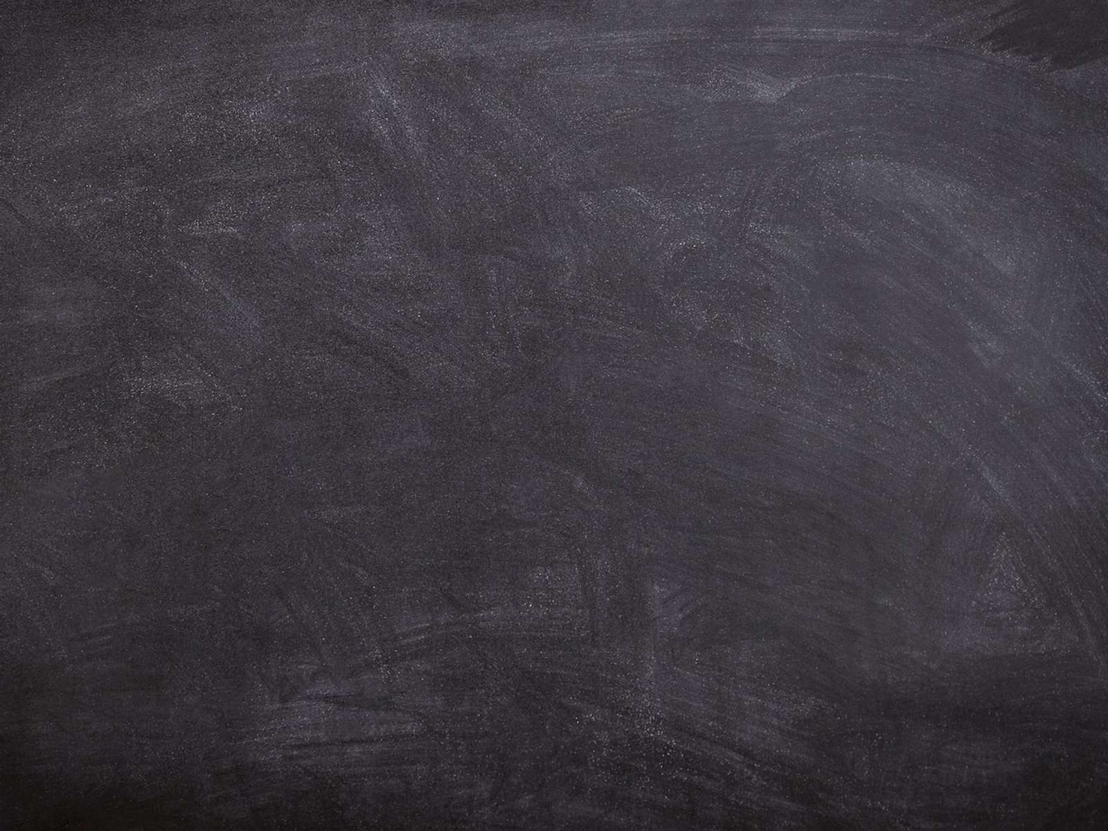 A black school chalkboard with traces of chalk