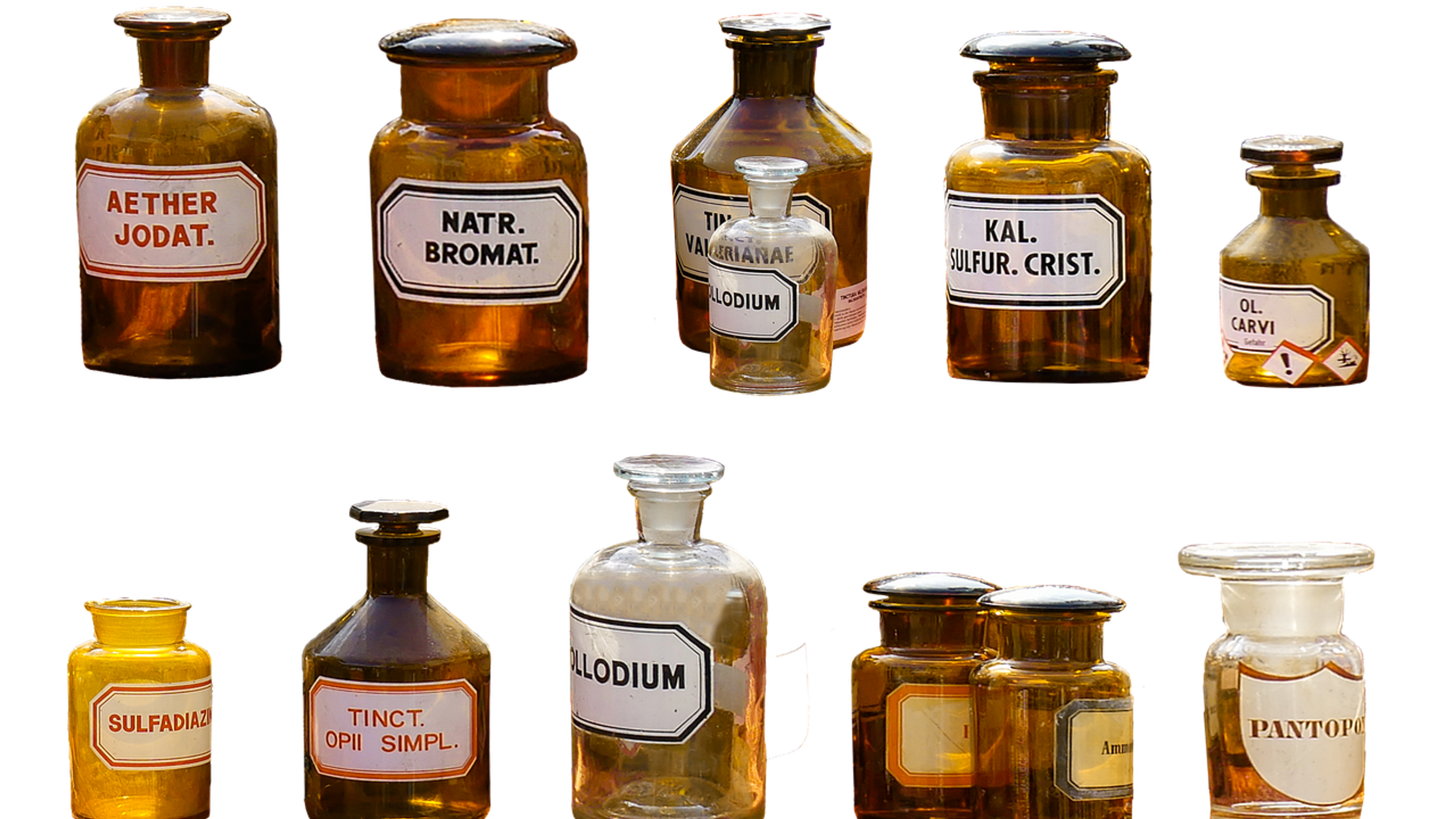 Old labelled glass bottles of chemicals on a white background