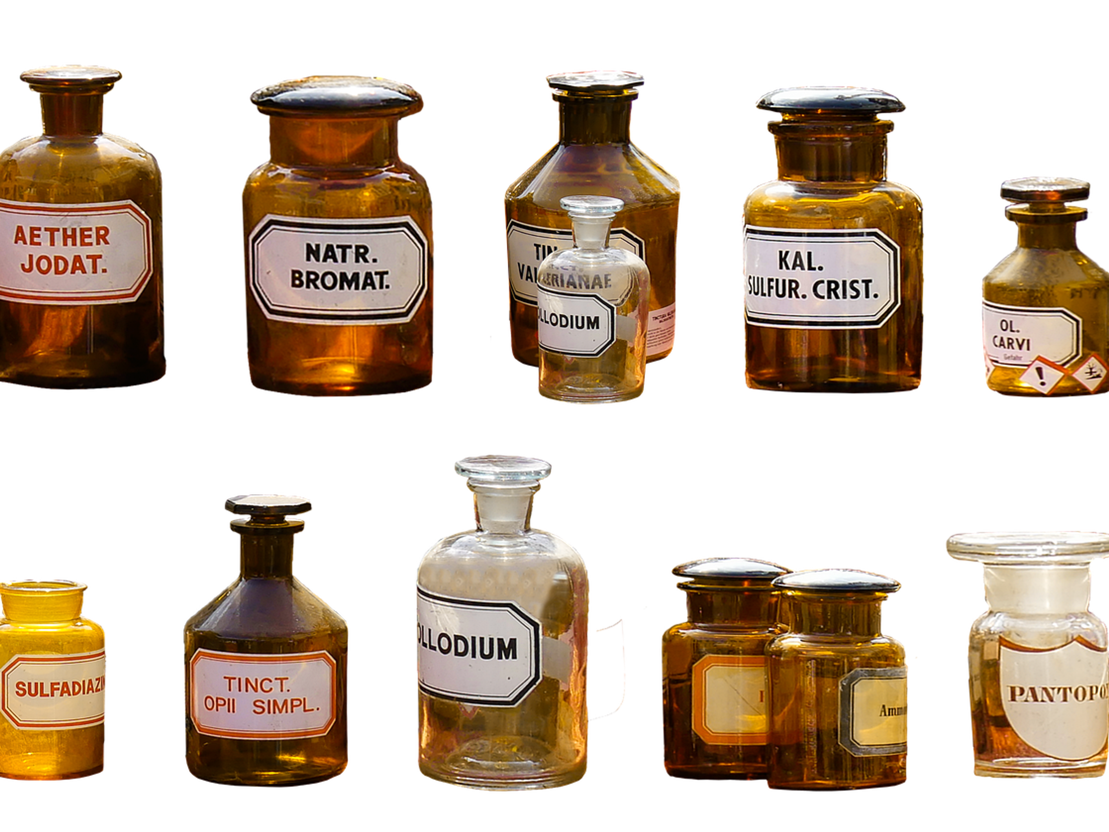 Old labelled glass bottles of chemicals on a white background