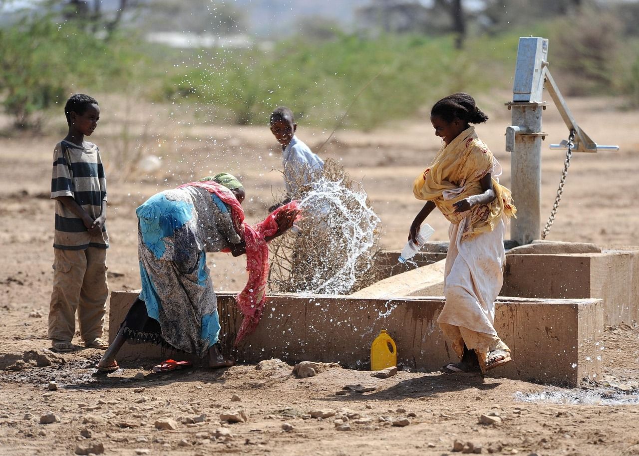 Children splashing and playing with water outdoors