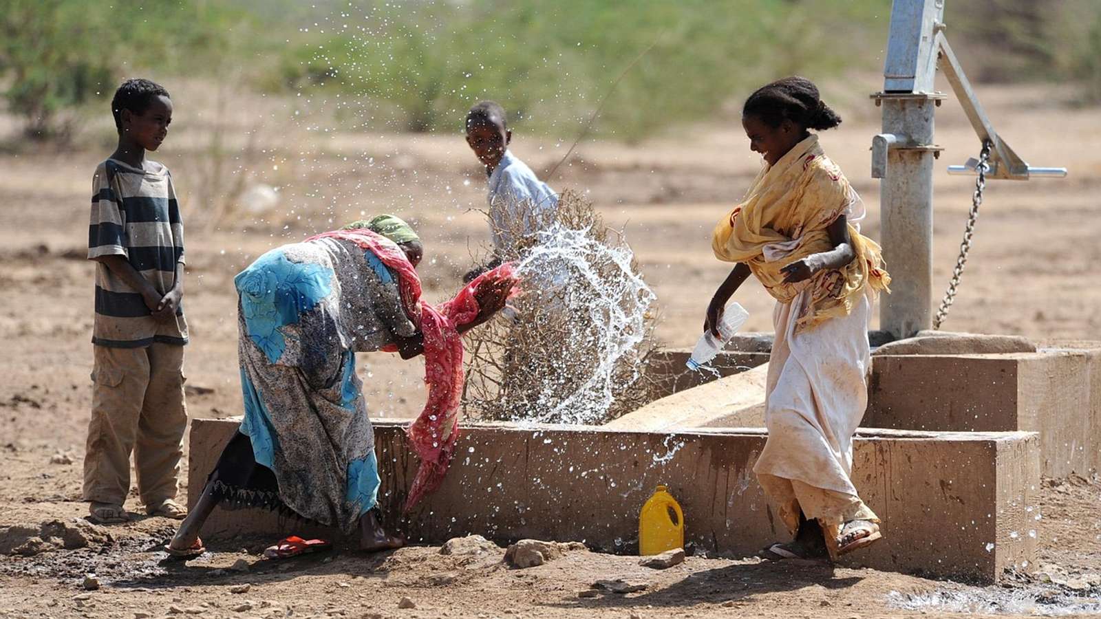 Children splashing and playing with water outdoors