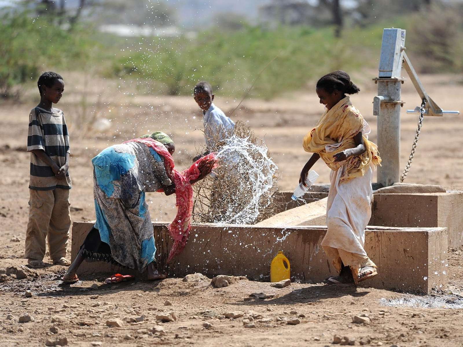Children splashing and playing with water outdoors