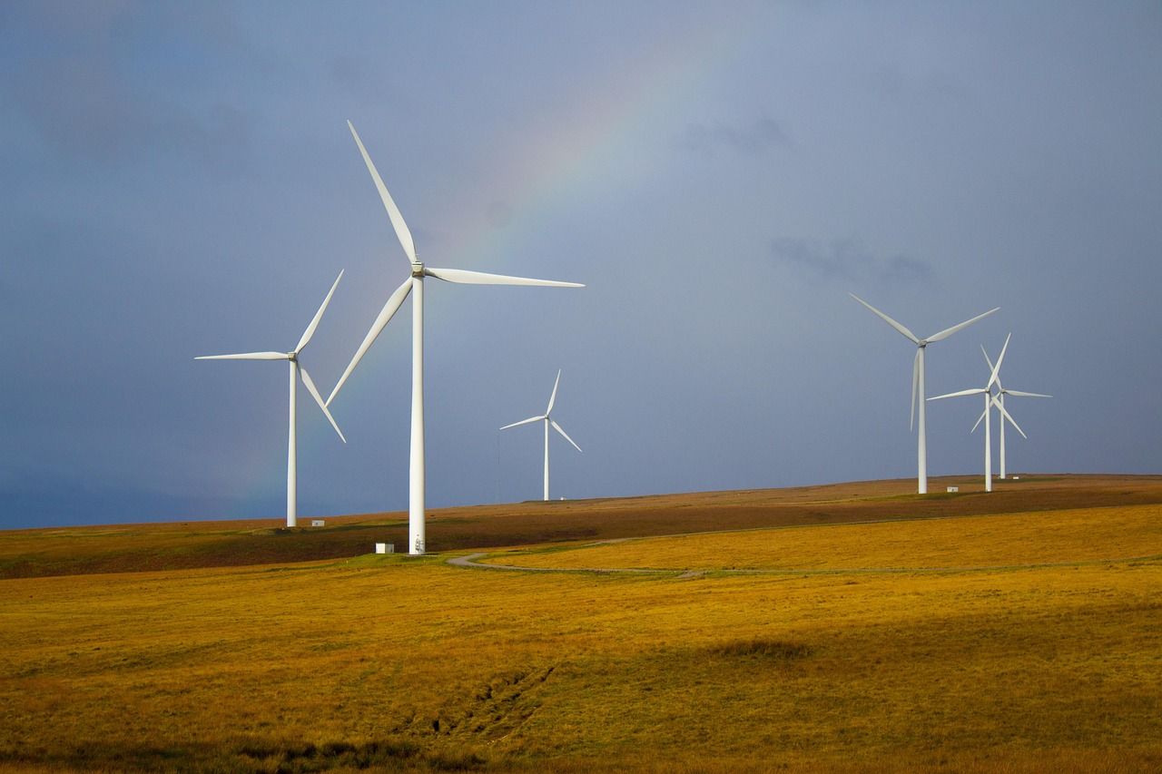 Wind turbines standing in a grassy field