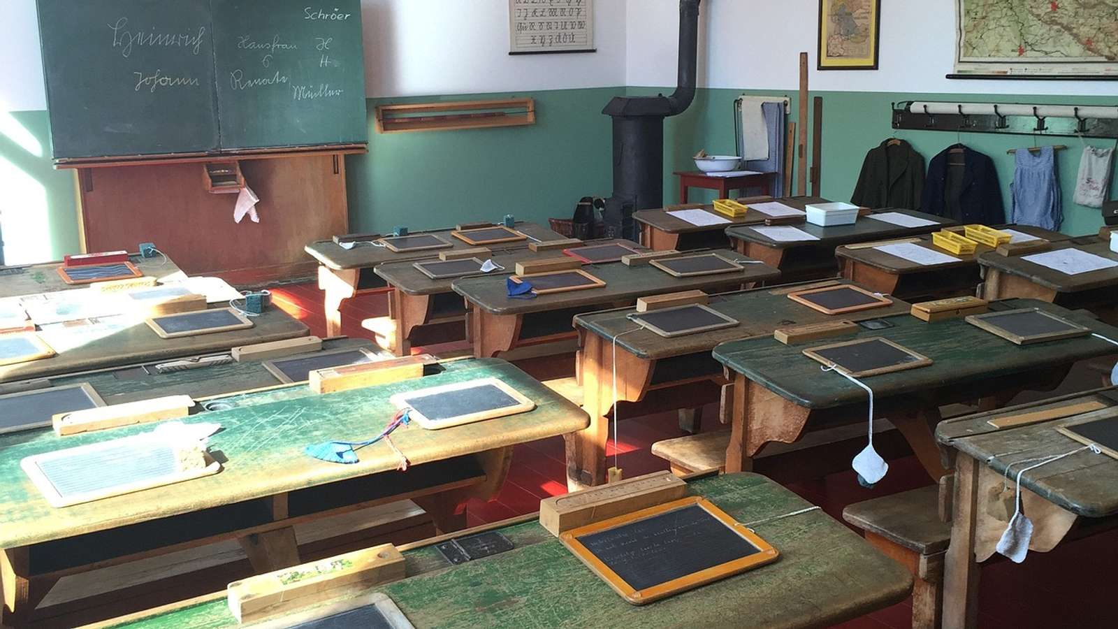 Old wooden school desks in a classroom