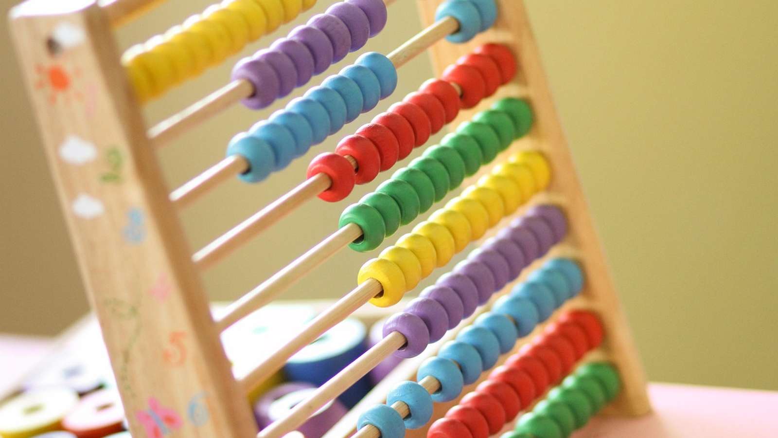Children counting with an abacus in a classroom