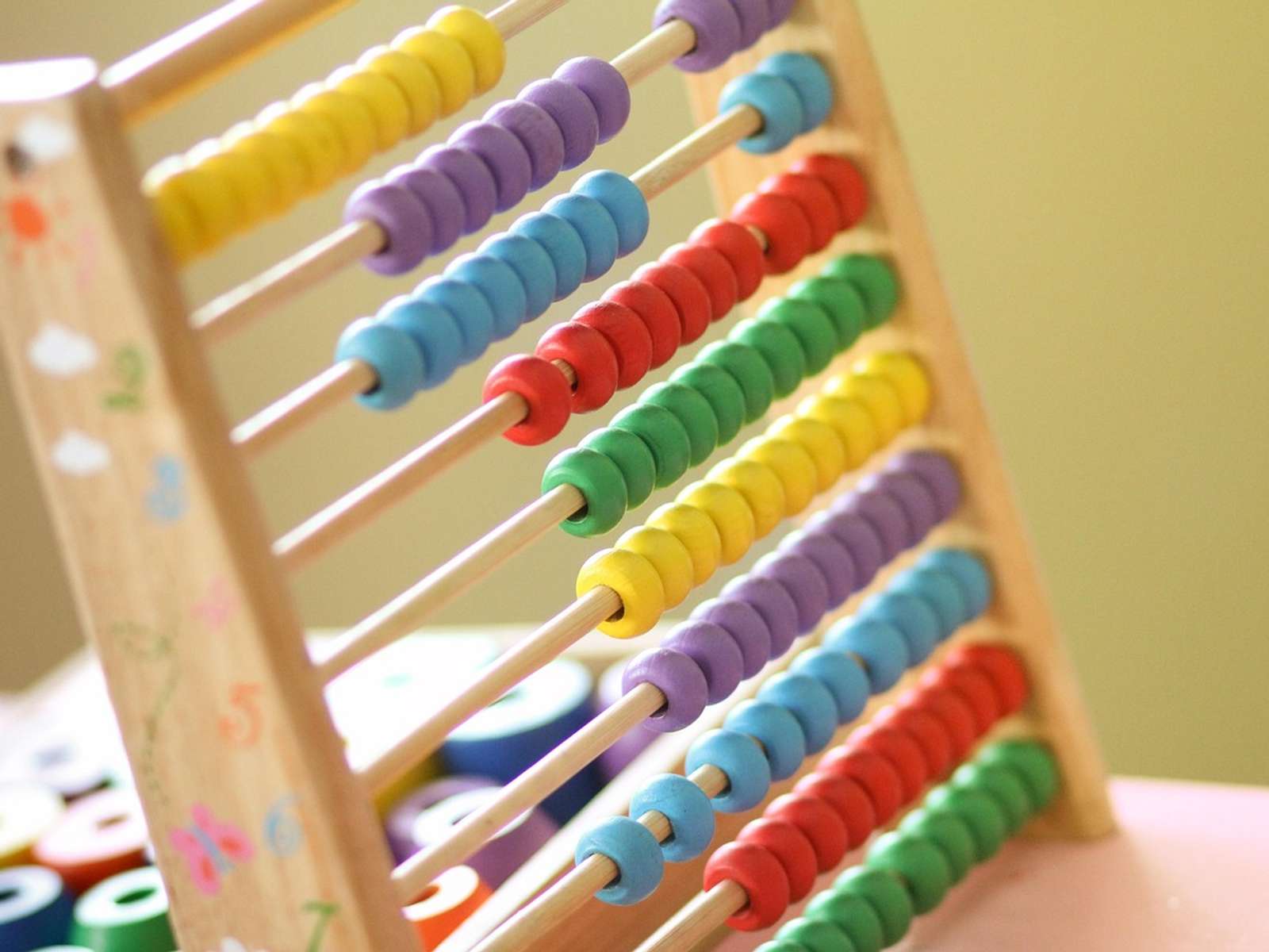 Children counting with an abacus in a classroom