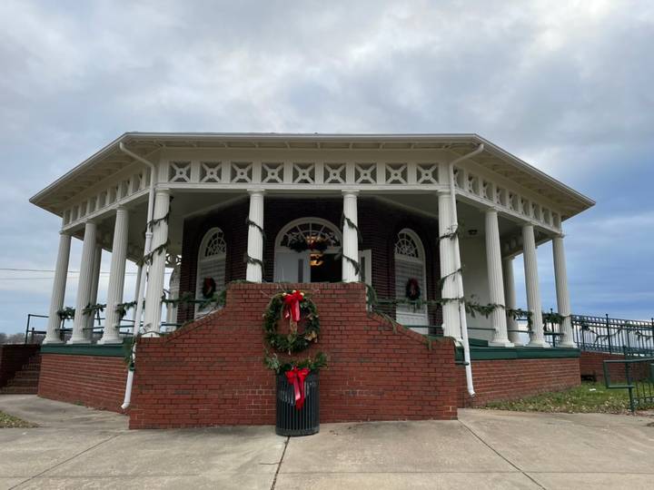 The Chimborazo Park Round House decorated with green wreaths and red bows for the holidays, set against a cloudy sky in Chimborazo Park.