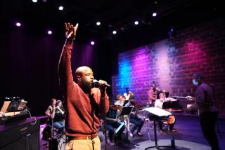 A performer raps with the orchestra.