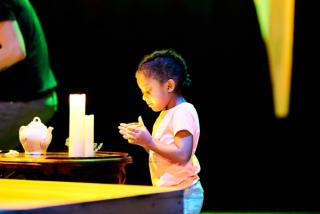 Young girl holding candle.