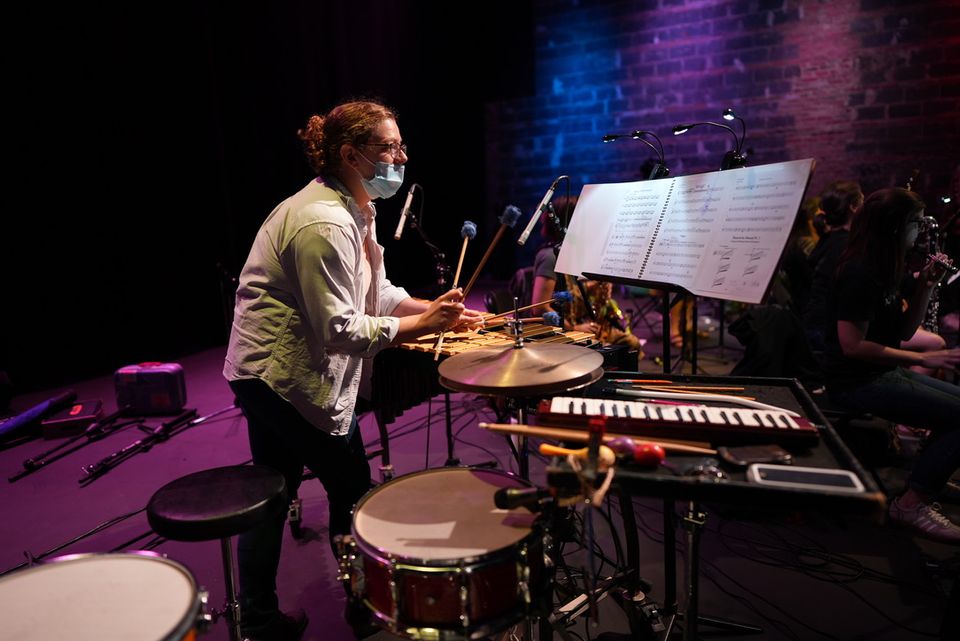 A percussionist performs with Mind on Fire