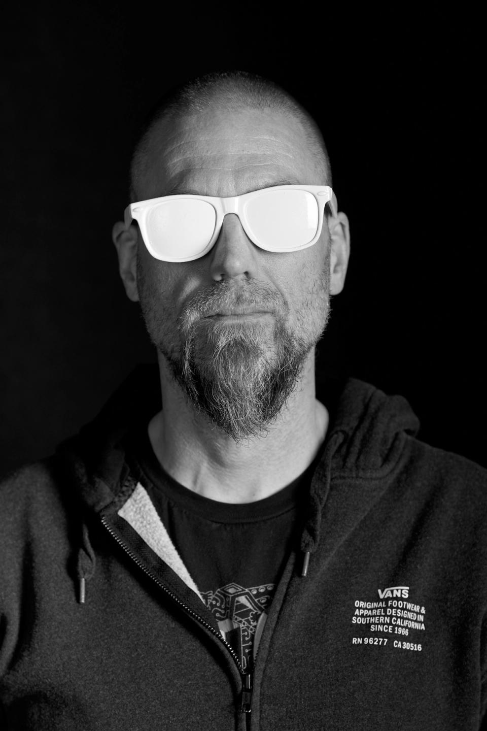 Jeff Carey wearing white sunglasses.