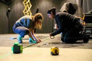 Two women construct the stars.