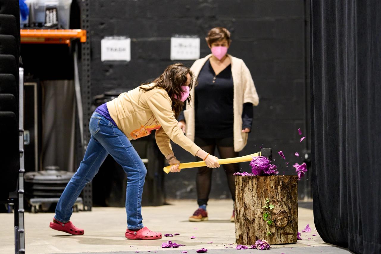 Britt practices axing a cabbage during rehearsal.