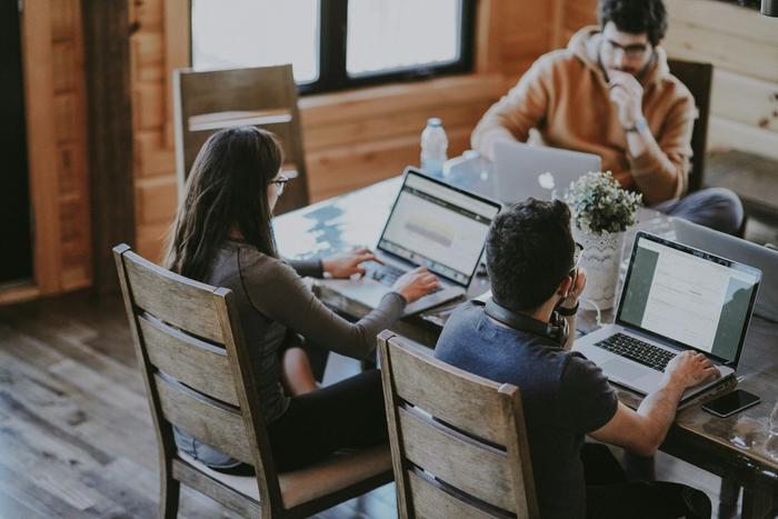 Three people working in an office
