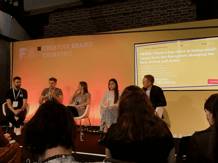 people sitting in front of a screen that says creative brand thinking