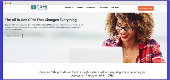 a woman with curly hair is smiling on the 1 crm website