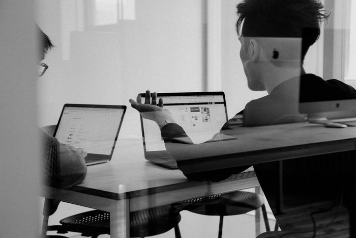 People use social media management tools at a desk.