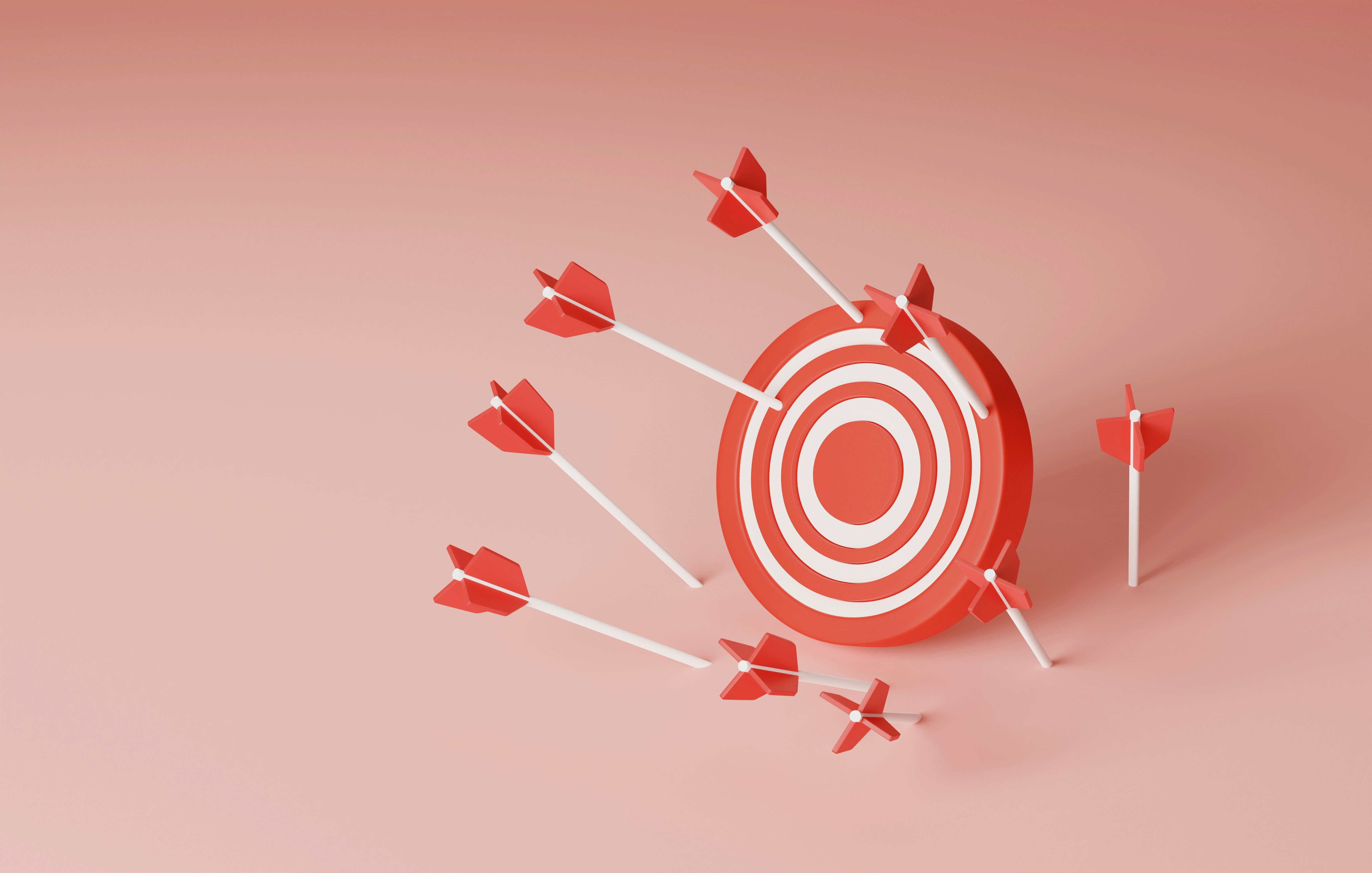 Red target with several arrows hitting and surrounding it on a pink background.