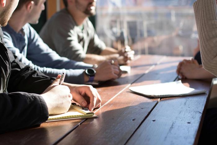 people having a meeting at a desk