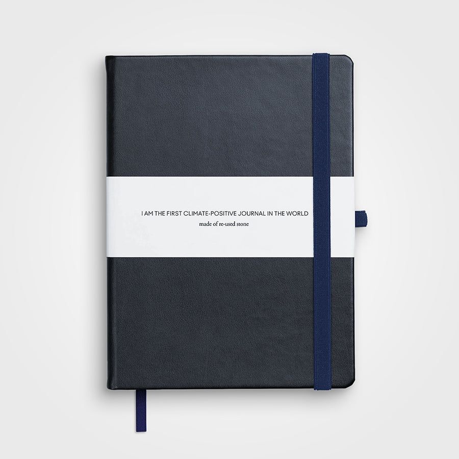 A black notebook with a blue strap and a white label.
