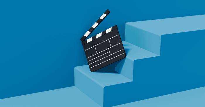 This illustrated image of a clapper board resting on steps represents visual content creation packages for social media.