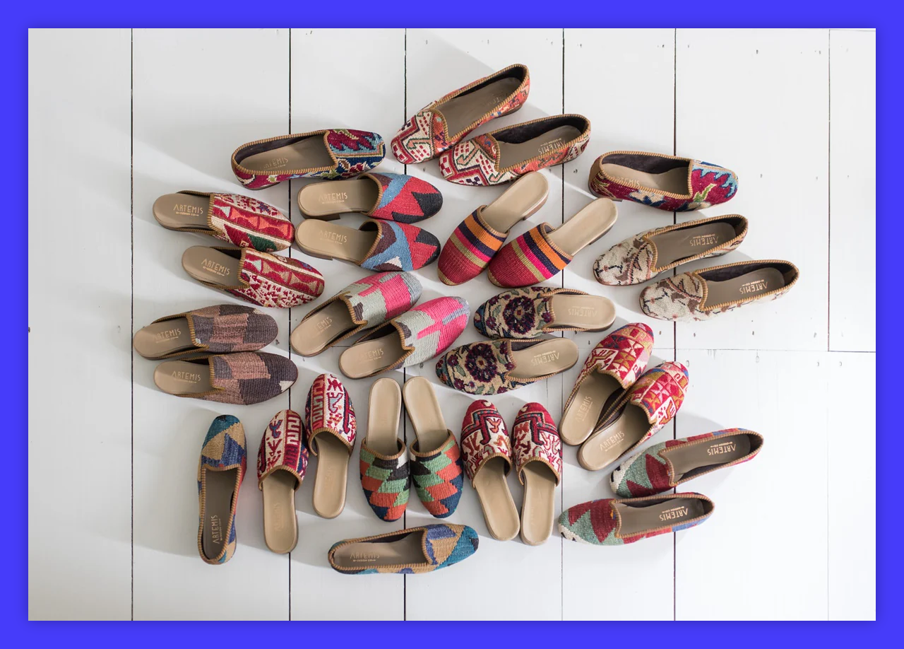 A bunch of colorful shoes lined up on a white surface.