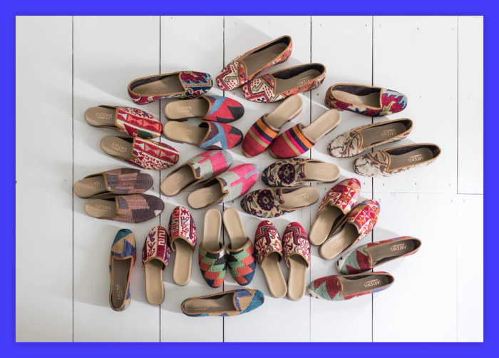 A bunch of colorful shoes lined up on a white surface.