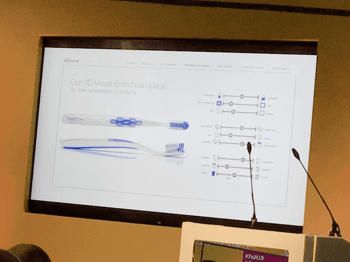 a screen shows a toothbrush and the words " our 3d visual brand language "