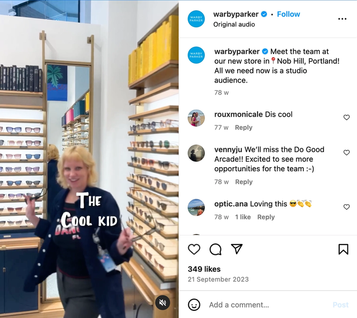a woman in an optical store with the words " the cool kid " on her shirt