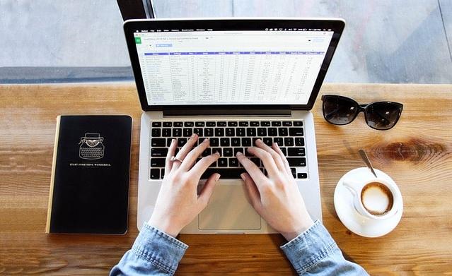 A person is typing on a laptop.
