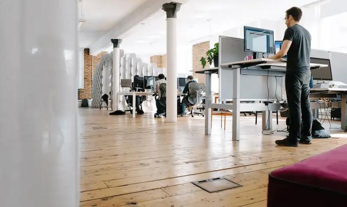 The Capsule office today - sitting and standing desks with various team members working