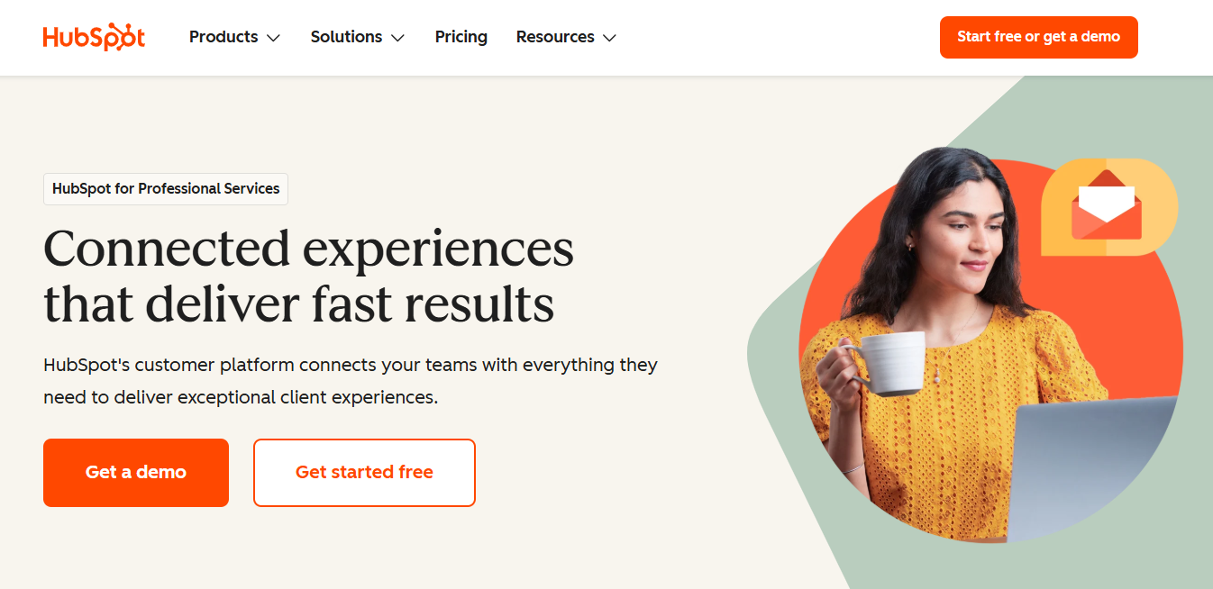 HubSpot webpage with a woman holding a mug and working on a laptop, alongside the text "Connected experiences that deliver fast results."