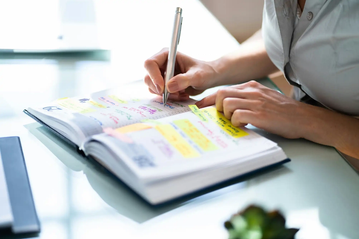 Event manager planning an event in a diary