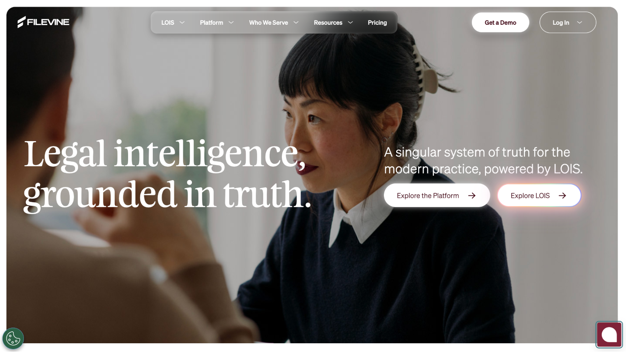 Filevine legal intelligence platform homepage showing a woman in conversation and the headline 'Legal intelligence, grounded in truth.'